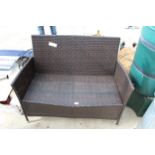 A TWO SEATER RATTAN GARDEN SETTEE