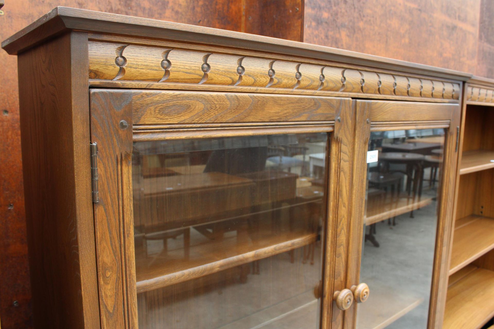 AN ERCOL BLONDE TWO DOOR BOOKCASE WITH CUPBOARD TO BASE 39.5" WIDE - Image 2 of 3