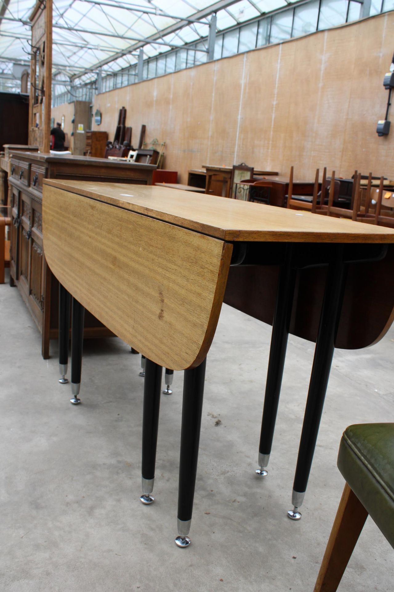 A RETRO TEAK DROP-LEAF DINING TABLE, 52" X 42" OPENED ON BLACK TAPERING LEGS WITH CHROME - Image 2 of 2