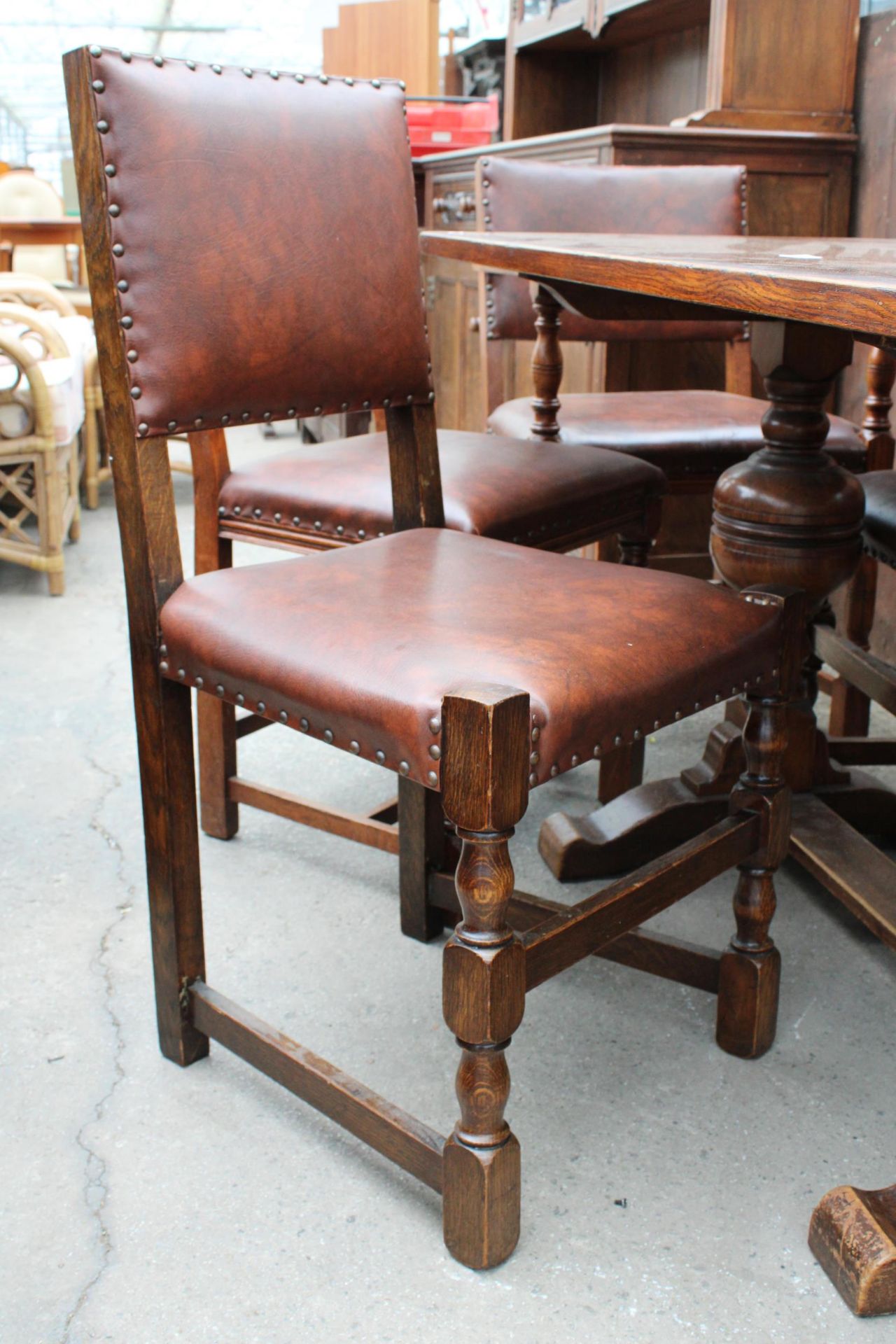 A MID 20TH CENTURY OAK REFECTORY TABLE, 57" X 30" AND NINE STUDDED DINING CHAIRS, ONE BEING A CARVER - Image 5 of 6