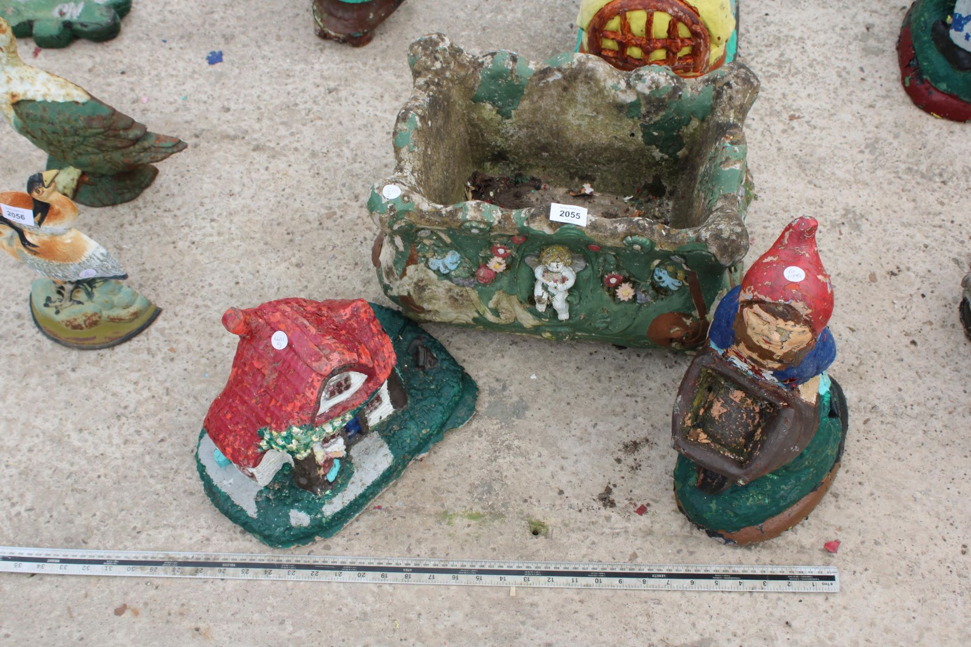 THREE CONCRETE GARDEN ITEMS TO INCLUDE A GNOME, A HOUSE AND A PLANTER