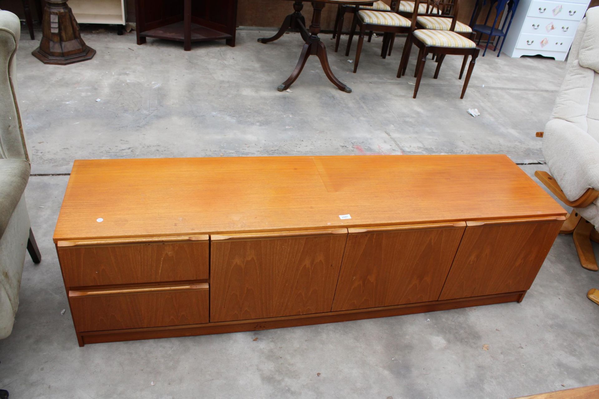 A RETRO TEAK LOW UNIT ENCLOSING TWO DRAWERS AND THREE CUPBOARDS, 72" WIDE