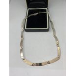 A SILVER BAR NECKLACE WITH A PRESENTATION BOX