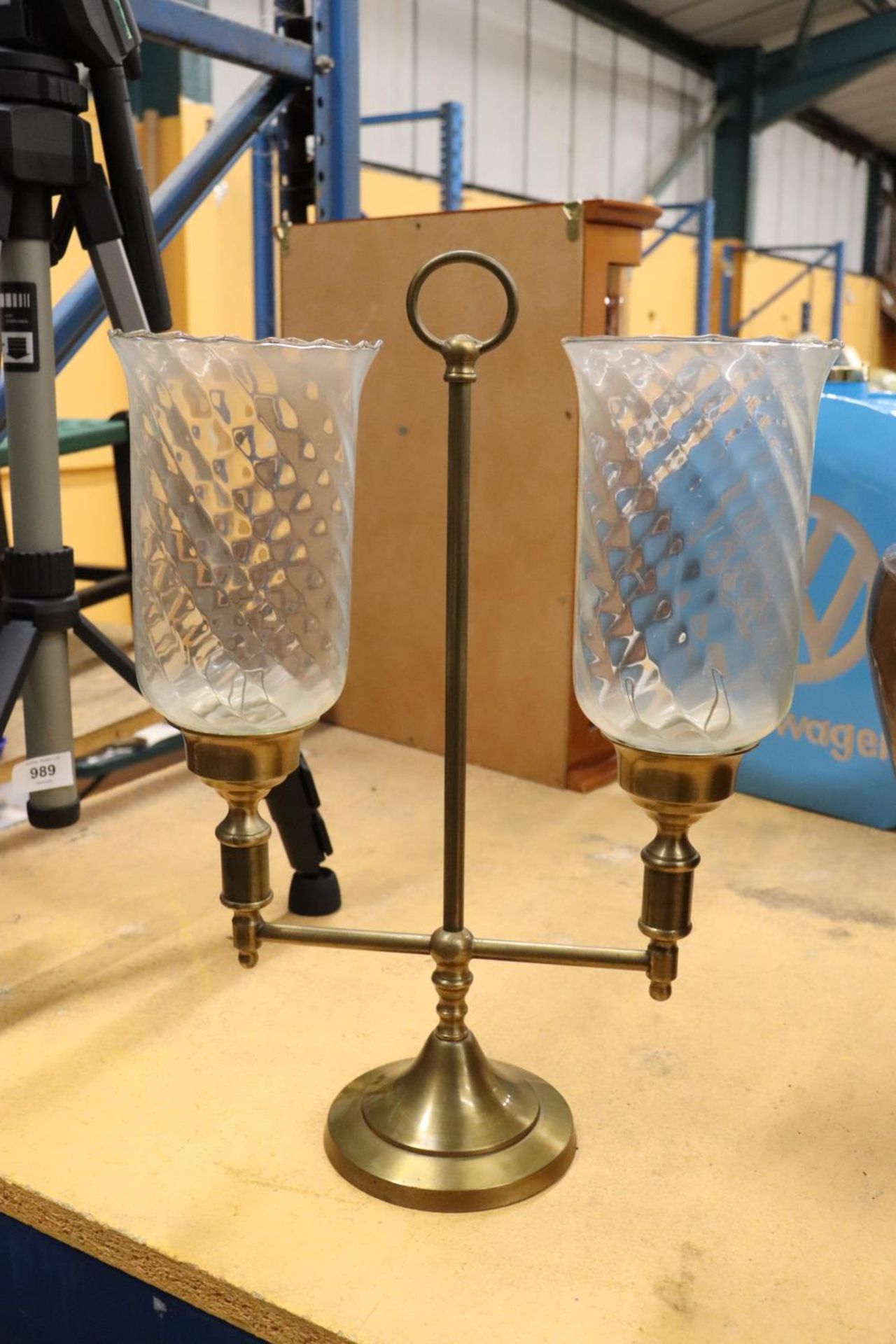 A BRASS TWO-ARM STUDENT CANDLE LAMP WITH HURRICANE SHADES