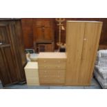 A PINE EFFECT TWO DOOR WARDROBE, CHEST OF FIVE DRAWERS AND A BEDSIDE CHEST