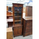 A NARROW MAHOGANY CROSS BANDED AND INLAID GLAZED BOOKCASE ON BASE ENCLOSING SINGLE DRAWER AND