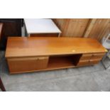 A RETRO TEAK PORTWOOD FURNITURE LOW UNIT ENCLOSING CUPBOARD AND DRAWERS, 72" WIDE