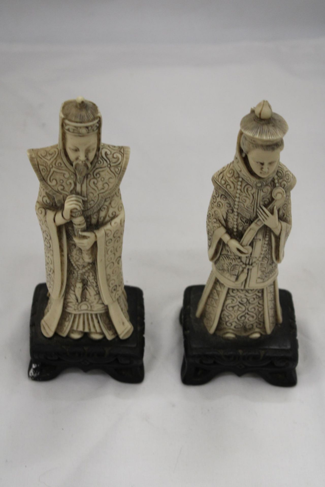 TWO ASIAN FIGURES ON BASES, WITH MARKINGS TO THE BASE, HEIGHT 22CM