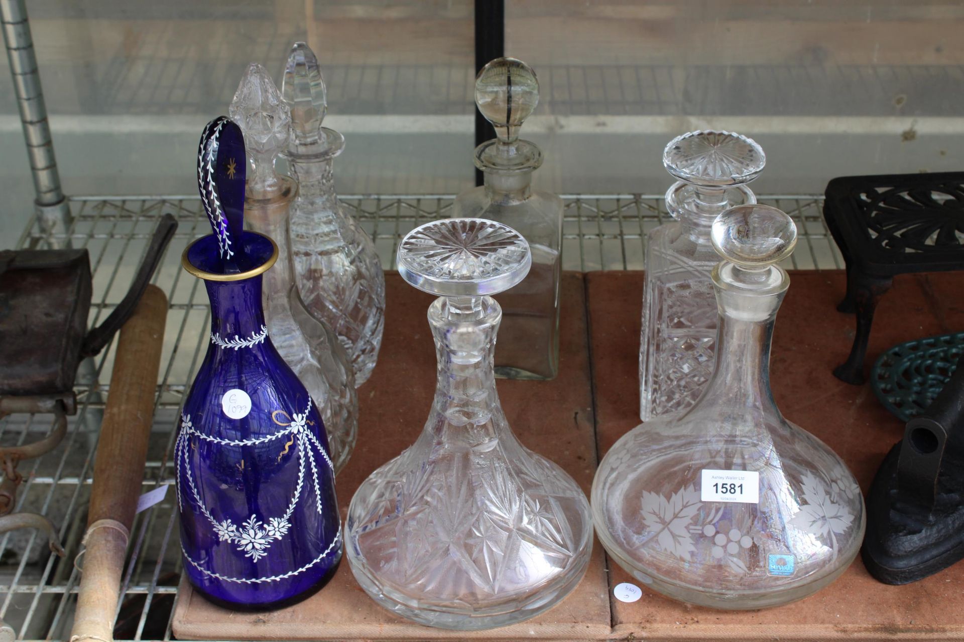 SEVEN VARIOUS GLASS DECANTORS COMPLETE WITH STOPPERS