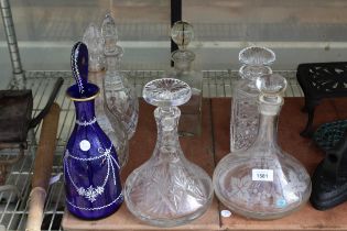 SEVEN VARIOUS GLASS DECANTORS COMPLETE WITH STOPPERS