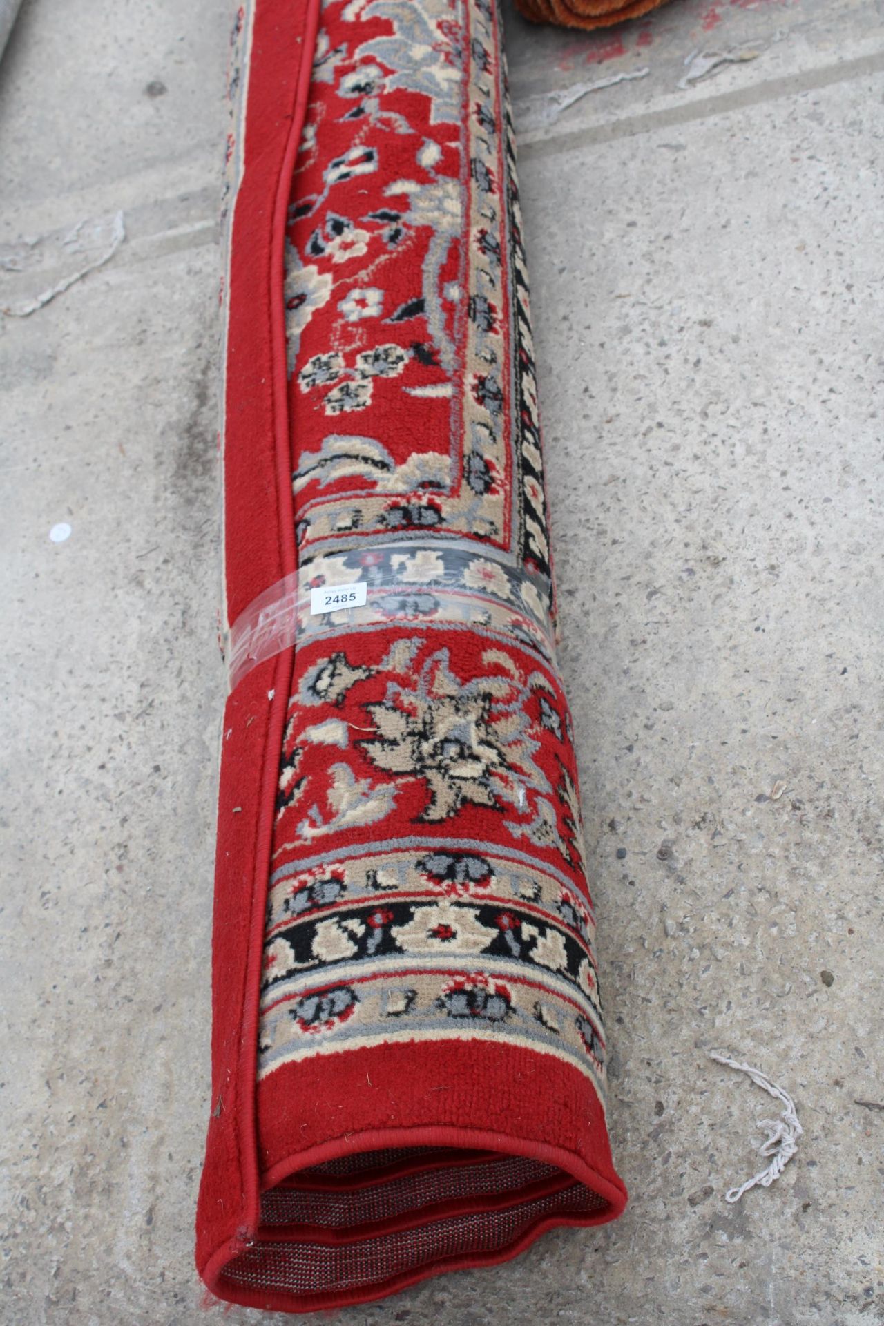 A LARGE RED PATTERNED RUG - Image 2 of 3