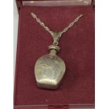 A SILVER BOTTLE NECKLACE IN A PRESENTATION BOX