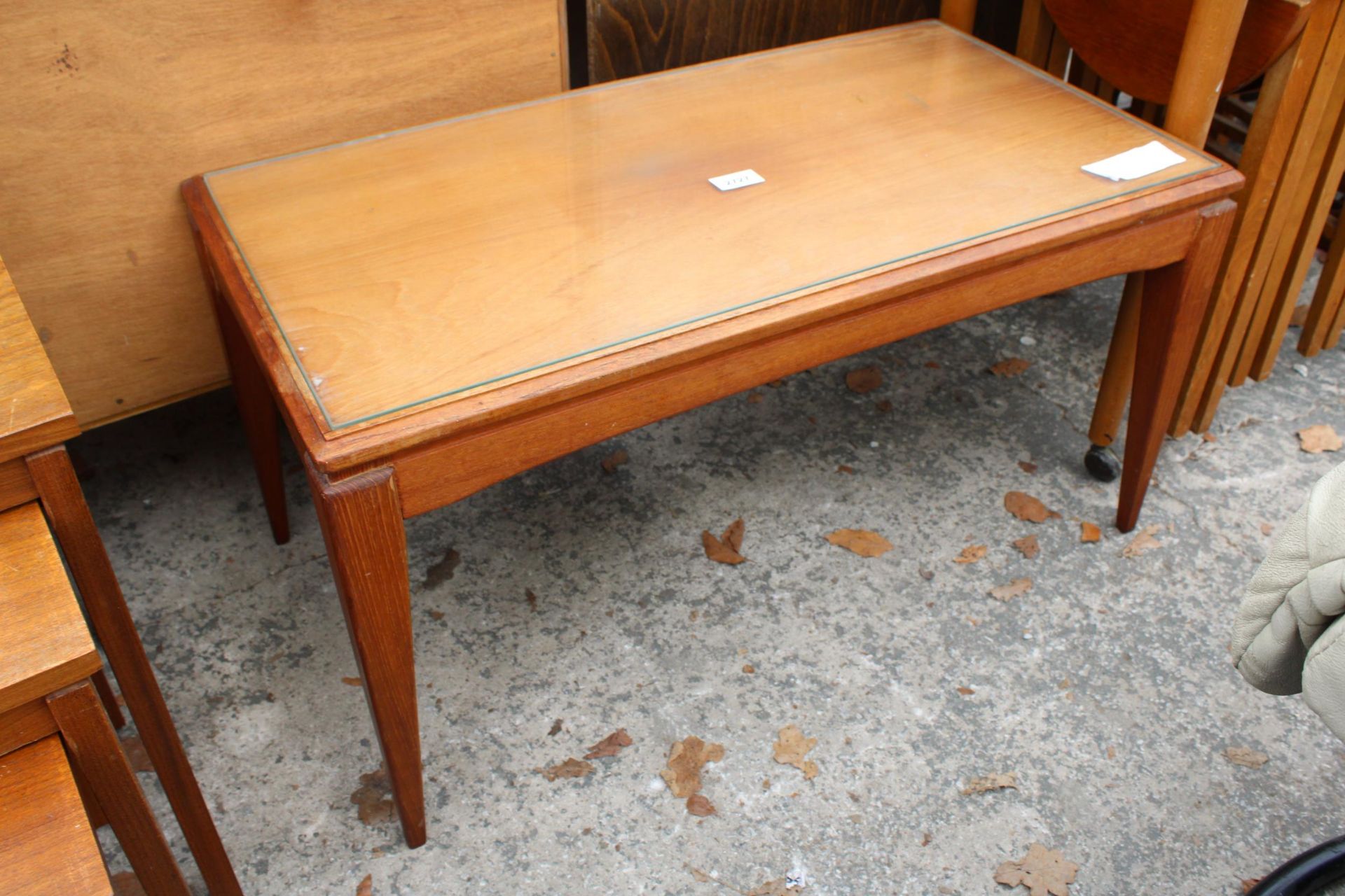 A RETRO TEAK COFFEE TABLE ON TAPERING LEGS, 30" X 16"