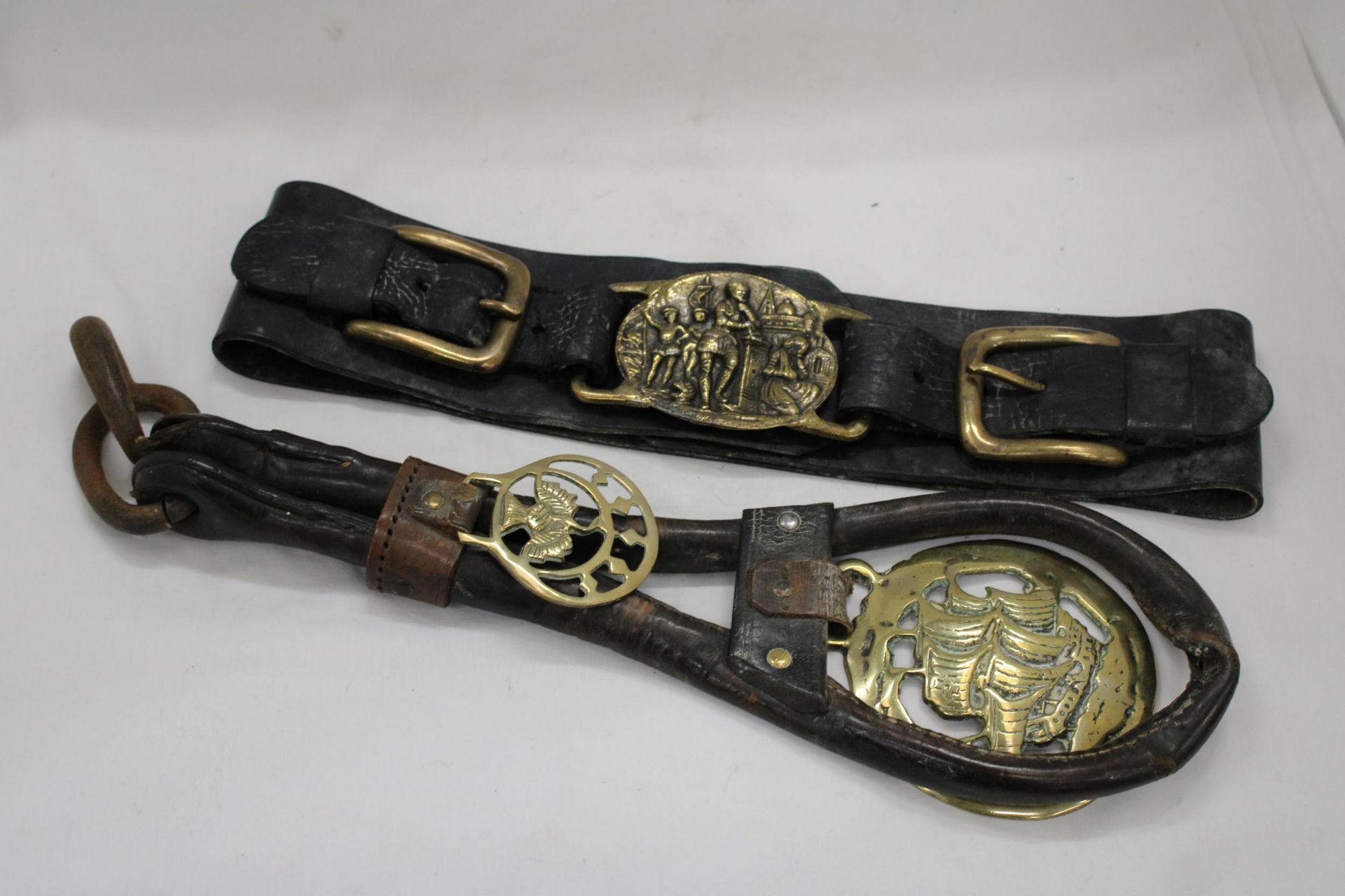 TWO HORSE BRASSES ON LEATHER STRAPS
