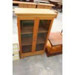 A MODERN OAK GLAZED TWO DOOR CABINET, 28" WIDE