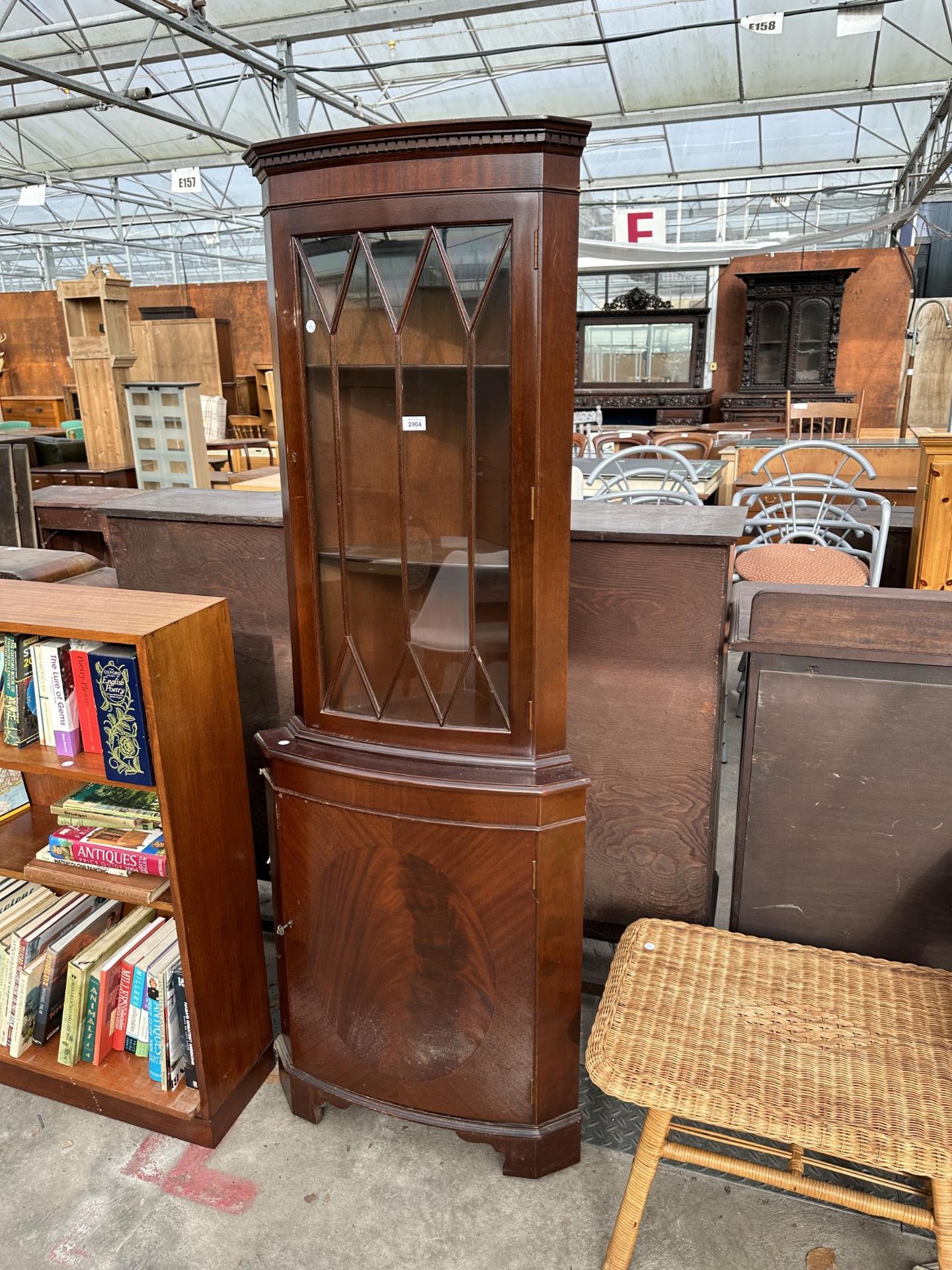 A MODERN CORNER CUPBOARD WITH GLAZED UPPER PORTION