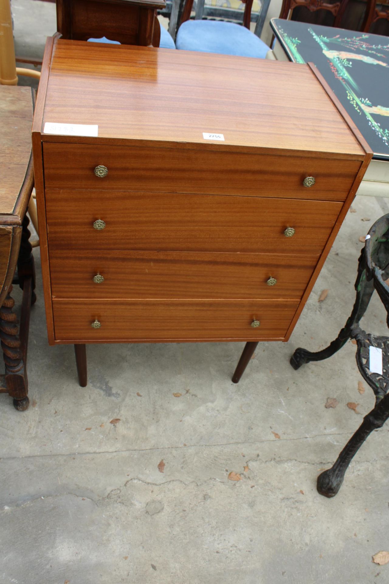 A RETRO TEAK CHEST OF FOUR DRAWERS ON TAPERING LEGS WITH BRASS HANDLES 25" WIDE