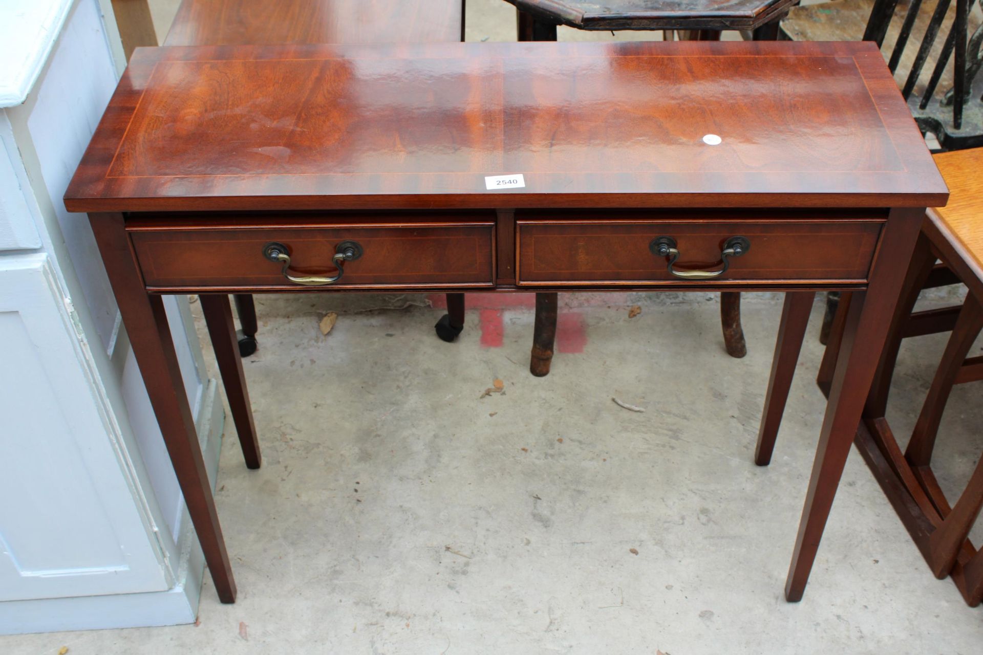 A MAHOGANY AND CROSSBANDED SIDE TABLE WITH TWO FRIEZE DRAWERS ON TAPERING LEGS 35" WIDE