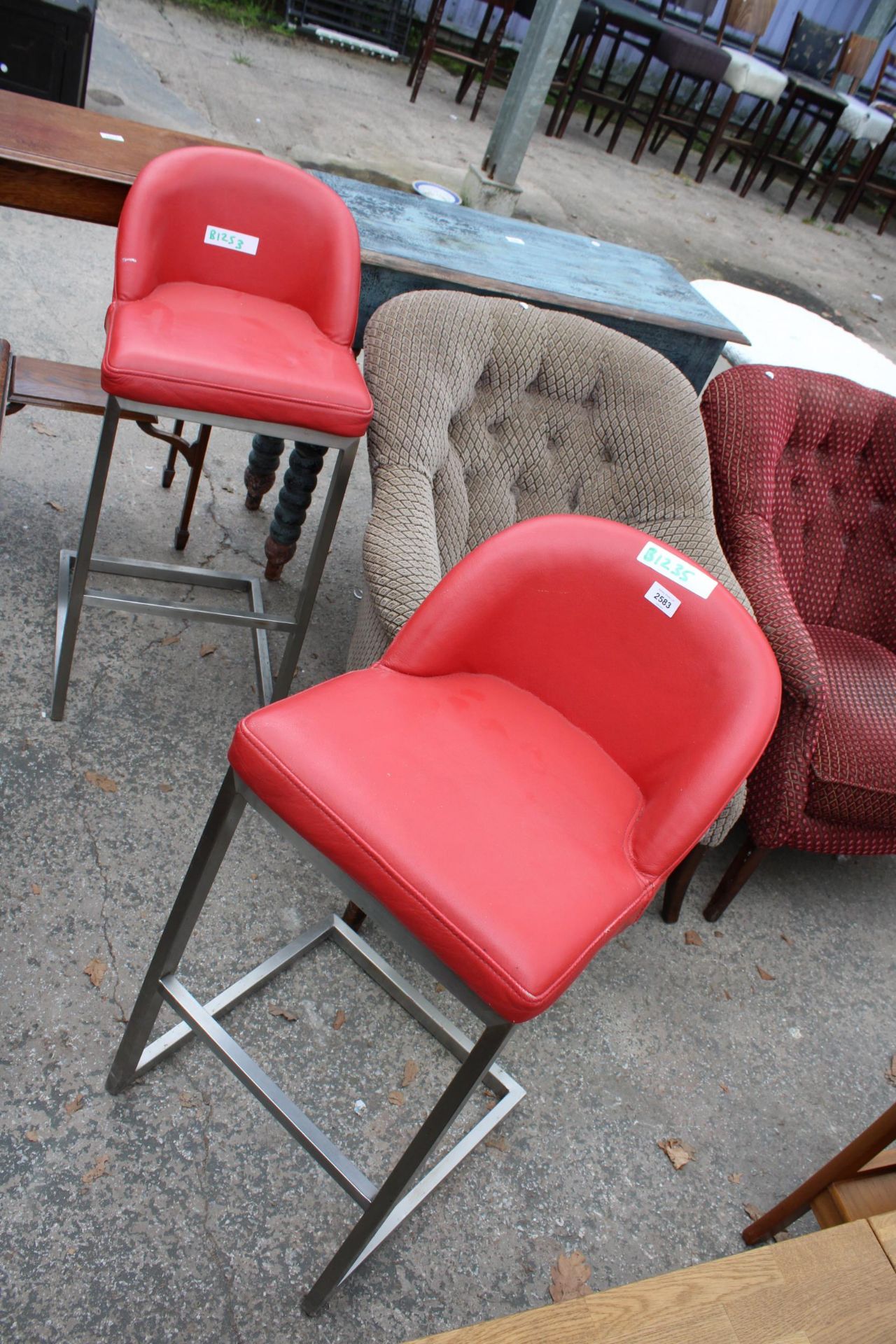 A PAIR OF HIGH BACK BAR STOOLS, STAINLESS STEEL FRAME WITH BRIGHT RED SEATS