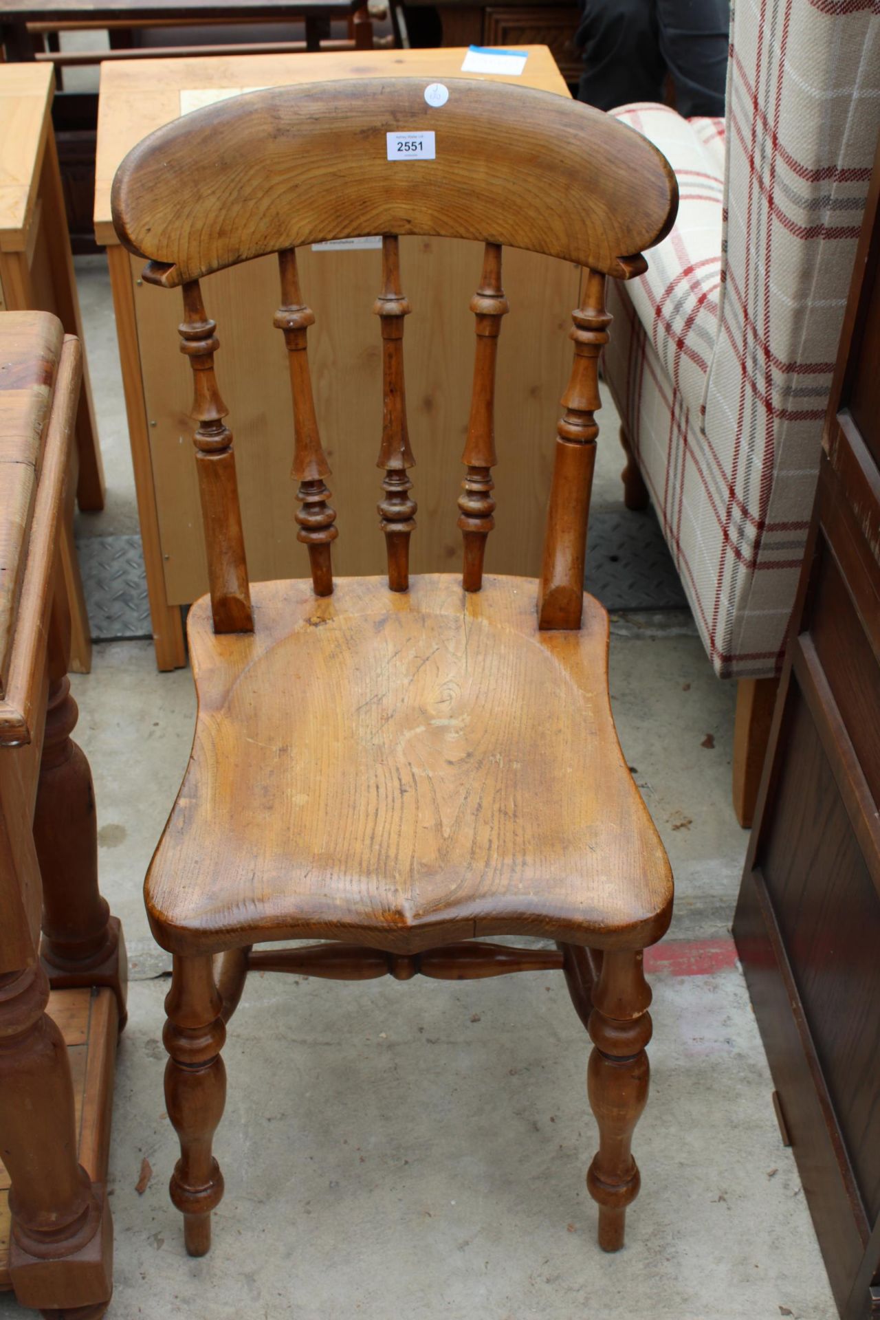 A VICTORIAN ELM AND BEECH KITCHEN CHAIR WITH TURNED UPRIGHT LEGS AND STRETCHERS