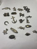 NINETEEN VARIOUS CHARMS SOME SILVER