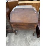 AN EARLY TWENTIETH CENTURY MAHOGANY BUREAU ON CABRIOLE LEGS WITH BALL AND CLAW FEET, 30" WIDE