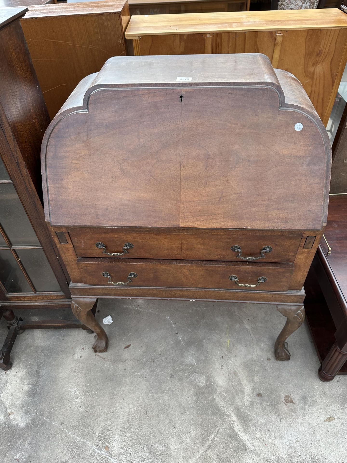 AN EARLY TWENTIETH CENTURY MAHOGANY BUREAU ON CABRIOLE LEGS WITH BALL AND CLAW FEET, 30" WIDE