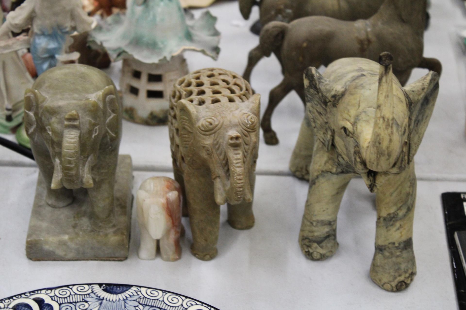 FOUR STONE ELEPHANTS OF VARYING SIZES