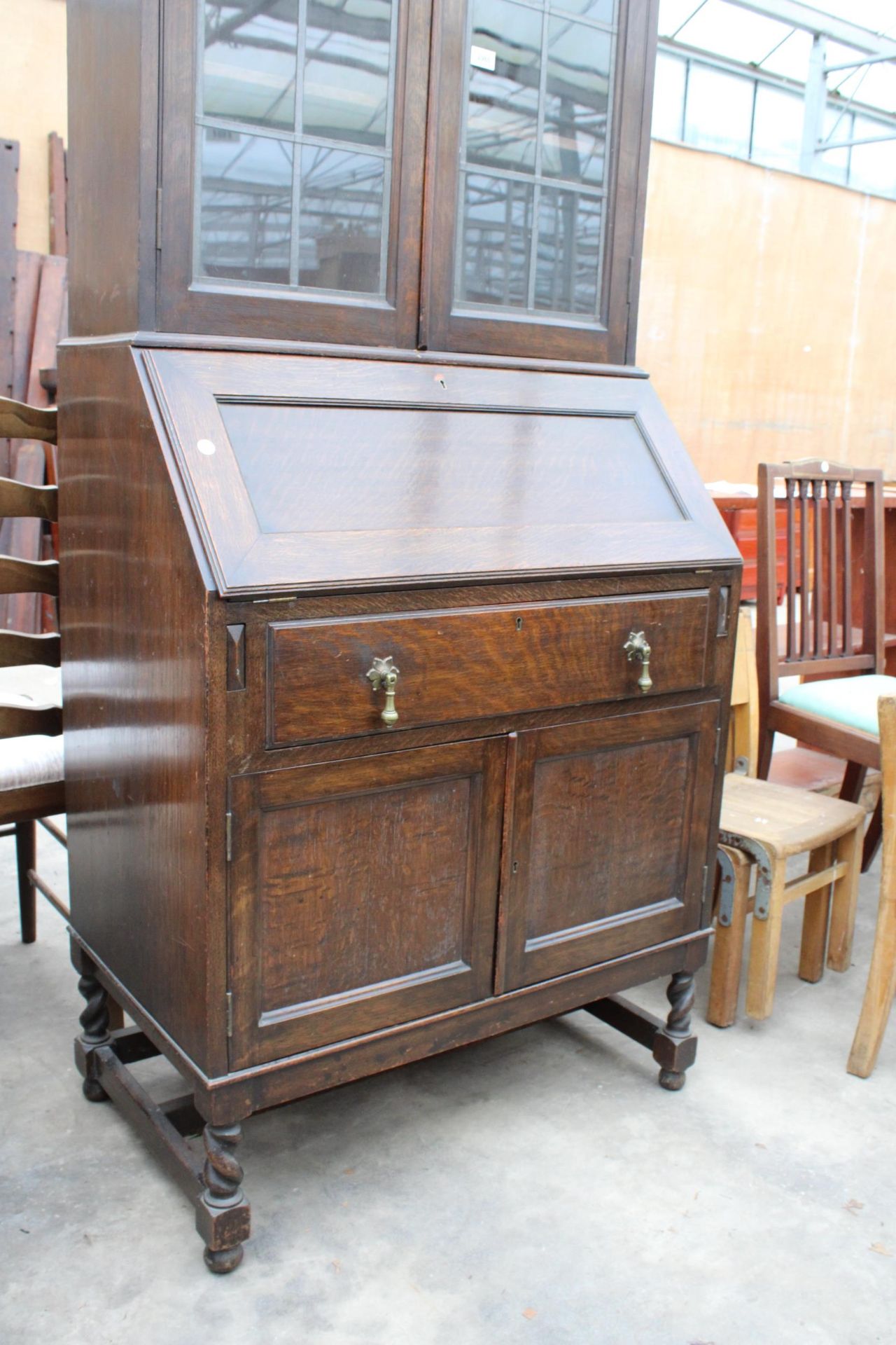 AN EARLY 20TH CENTURY OAK BUREAU BOOKCASE WITH GLAZED AND LEADED UPPER PORTION ENCLOSING CUTLERY - Image 2 of 7