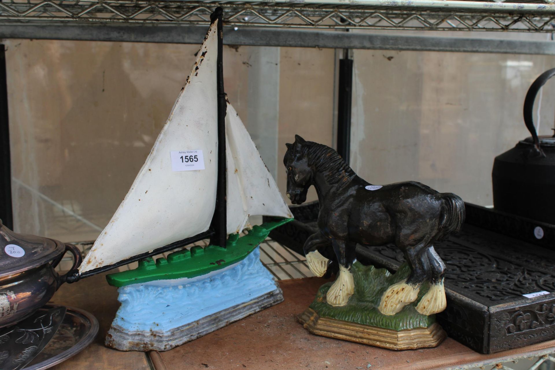 TWO CAST IRON DOOR STOPS, ONE IN THE FORM OF A SHIRE HORSE AND THE OTHER A BOAT