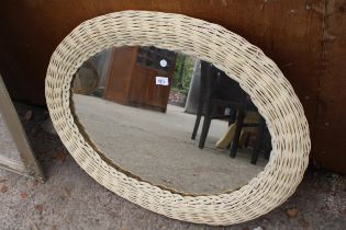 A MODERN OVAL WICKER FRAMED WALL MIRROR, 34" X 27"