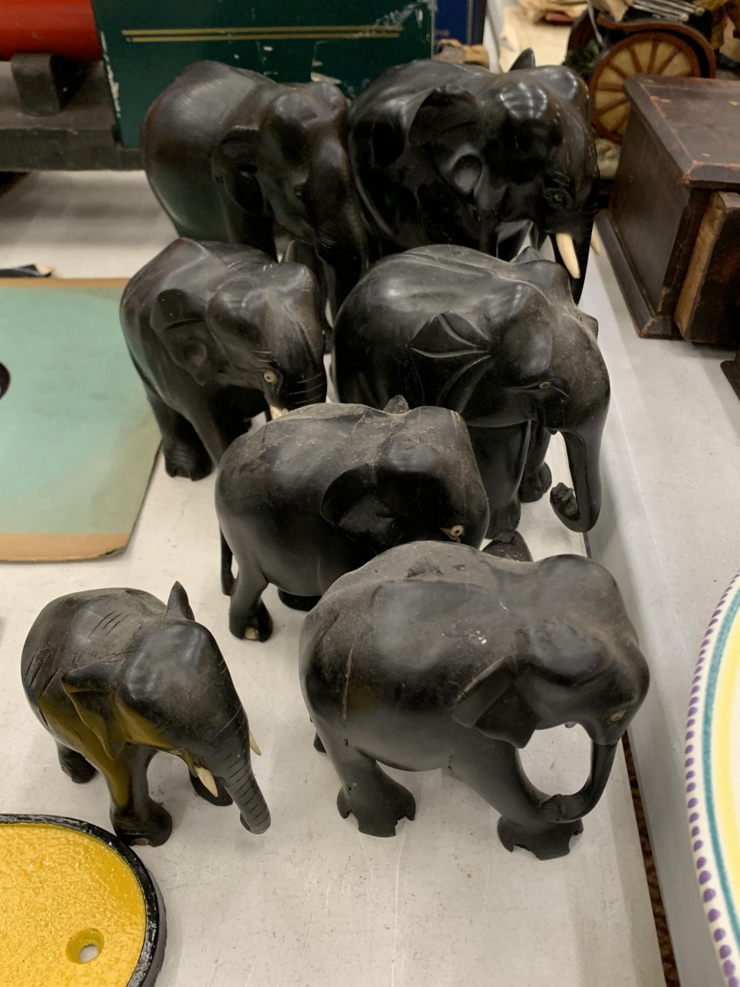 A COLLECTION OF SEVEN WOODEN ASIAN ELEPHANTS