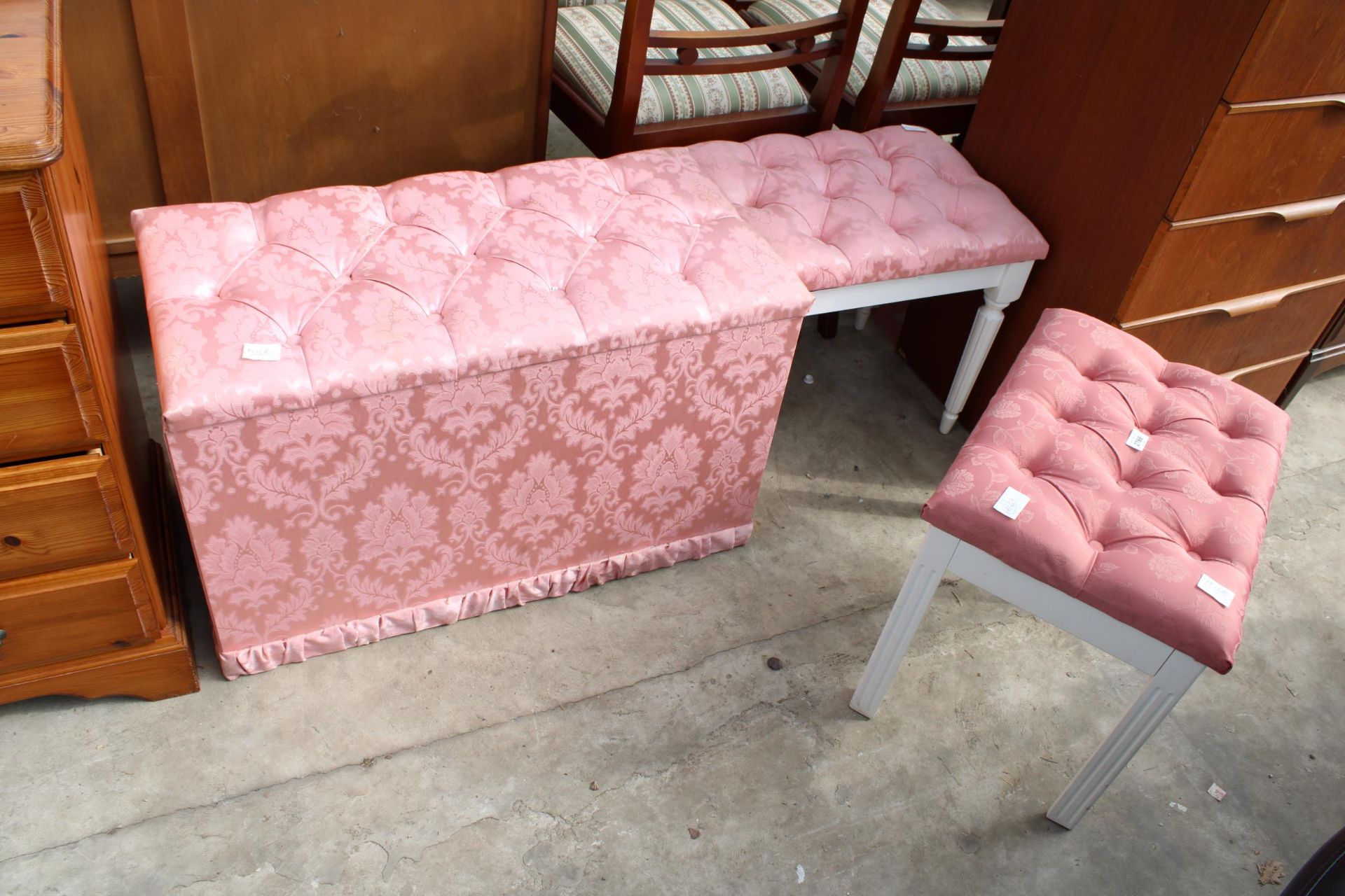 A MODERN PINK OTTOMAN AND TWO PINK STOOLS