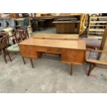 A MCINTOSH RETRO TEAK DRESSING TABLE ENCLOSING FIVE DRAWERS, 55.5" WIDE ON TAPERING LEGS