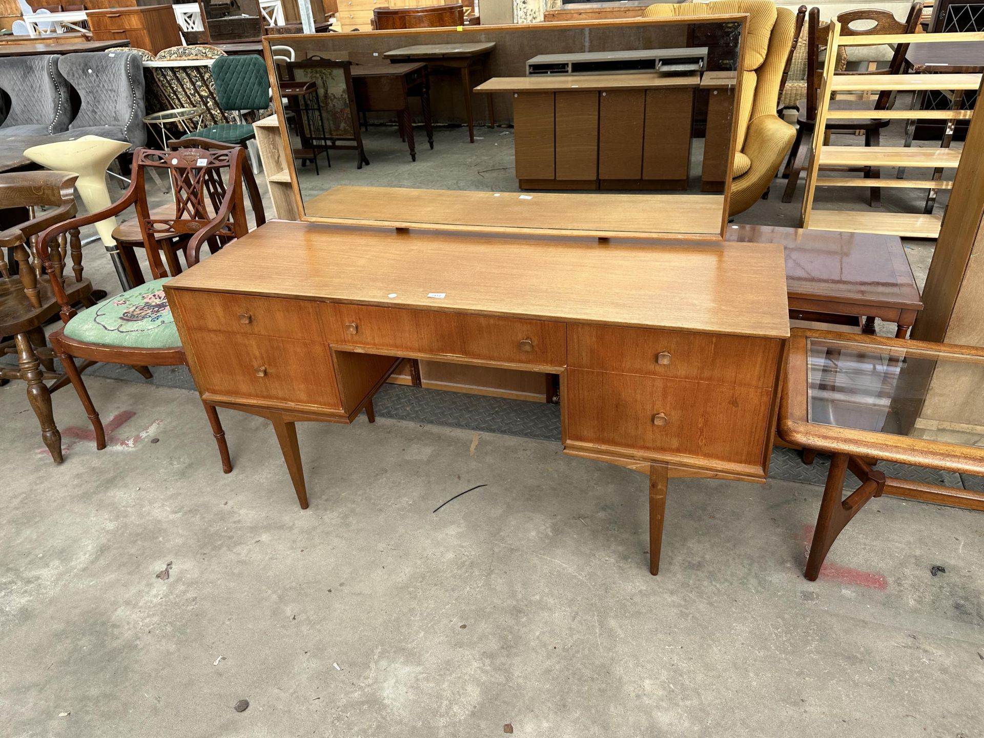 A MCINTOSH RETRO TEAK DRESSING TABLE ENCLOSING FIVE DRAWERS, 55.5" WIDE ON TAPERING LEGS