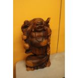 A CARVED WOODEN LAUGHING BUDDAH FIGURE 20" TALL