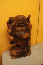 A CARVED WOODEN LAUGHING BUDDAH FIGURE 20" TALL
