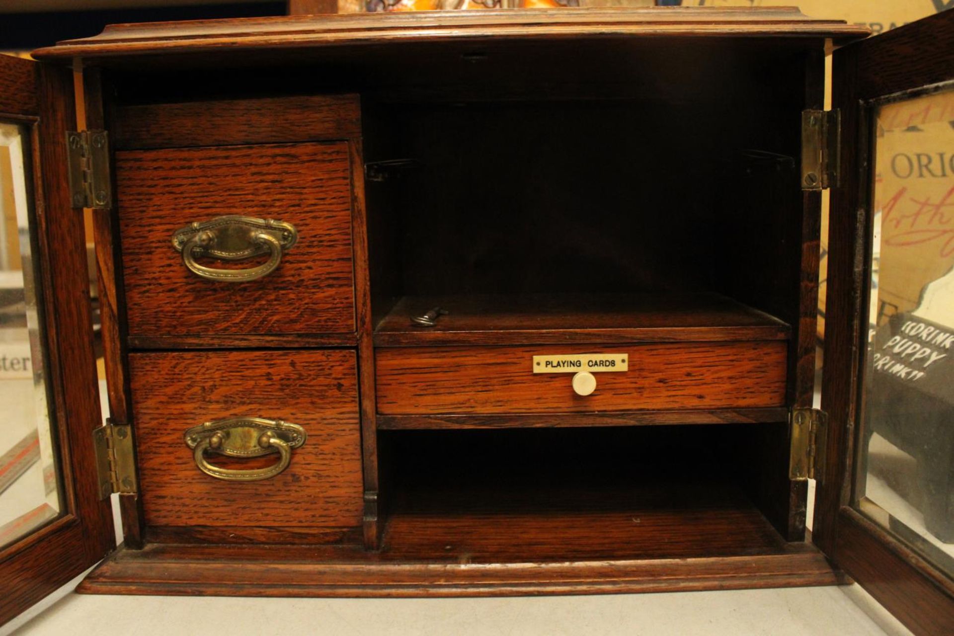 AN OAK TWO GLASS DOOR SMOKERS CABINET WITH THREE INTERIOR DRAWERS ONE LABELED PLAYING CARDS COMPLETE - Image 2 of 4