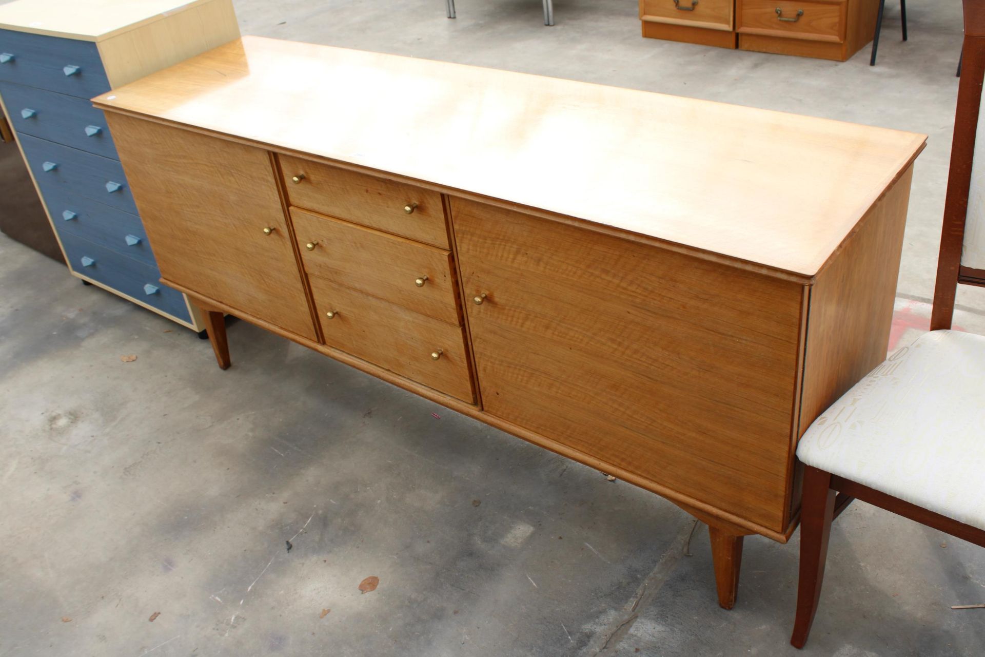 A RETRO HANDCRAFT ALFRED COX WALNUT SIDEBOARD ENCLOSING THREE DRAWERS AND TWO CUPBOARDS, 67" WIDE