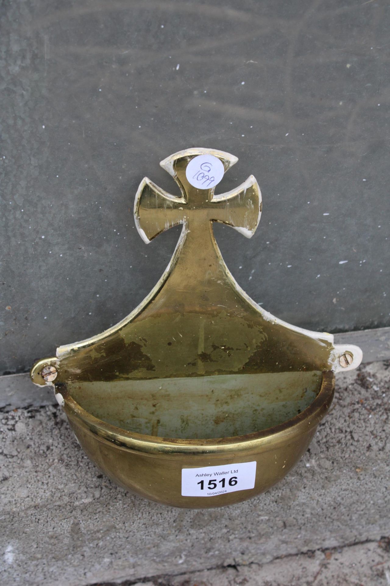 A VINTAGE BRASS WALL MOUNTED HOLY WATER CARRIER