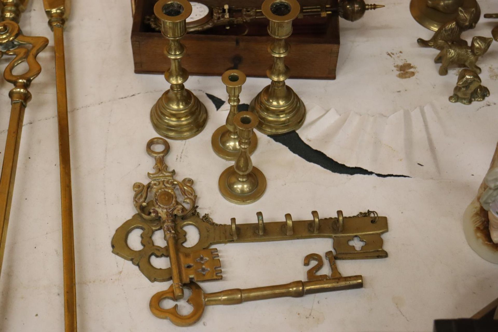 THREE BRASS KEYS AND TWO SMALL PAIRS OF CANDLESTICKS