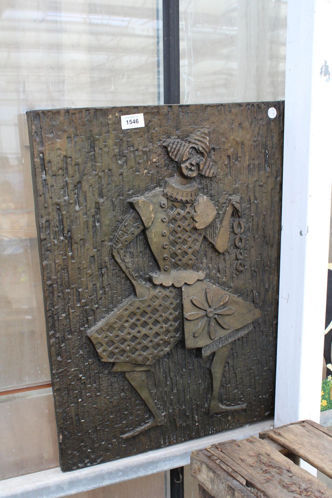 A FIBRE GLASS WALL PLAQUE OF A CLOWN