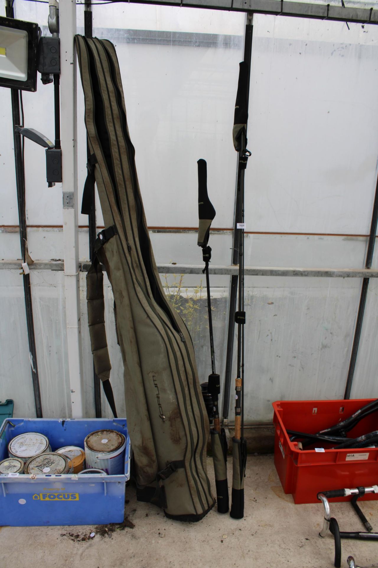 A ROD CARRYING BAG AND TWO VARIOUS FISHING RODS