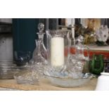 A QUANTITY OF GLASSWARE TO INCLUDE DECANTERS, BOWLS, VASES, CANDLE HURRICANE, ETC.,