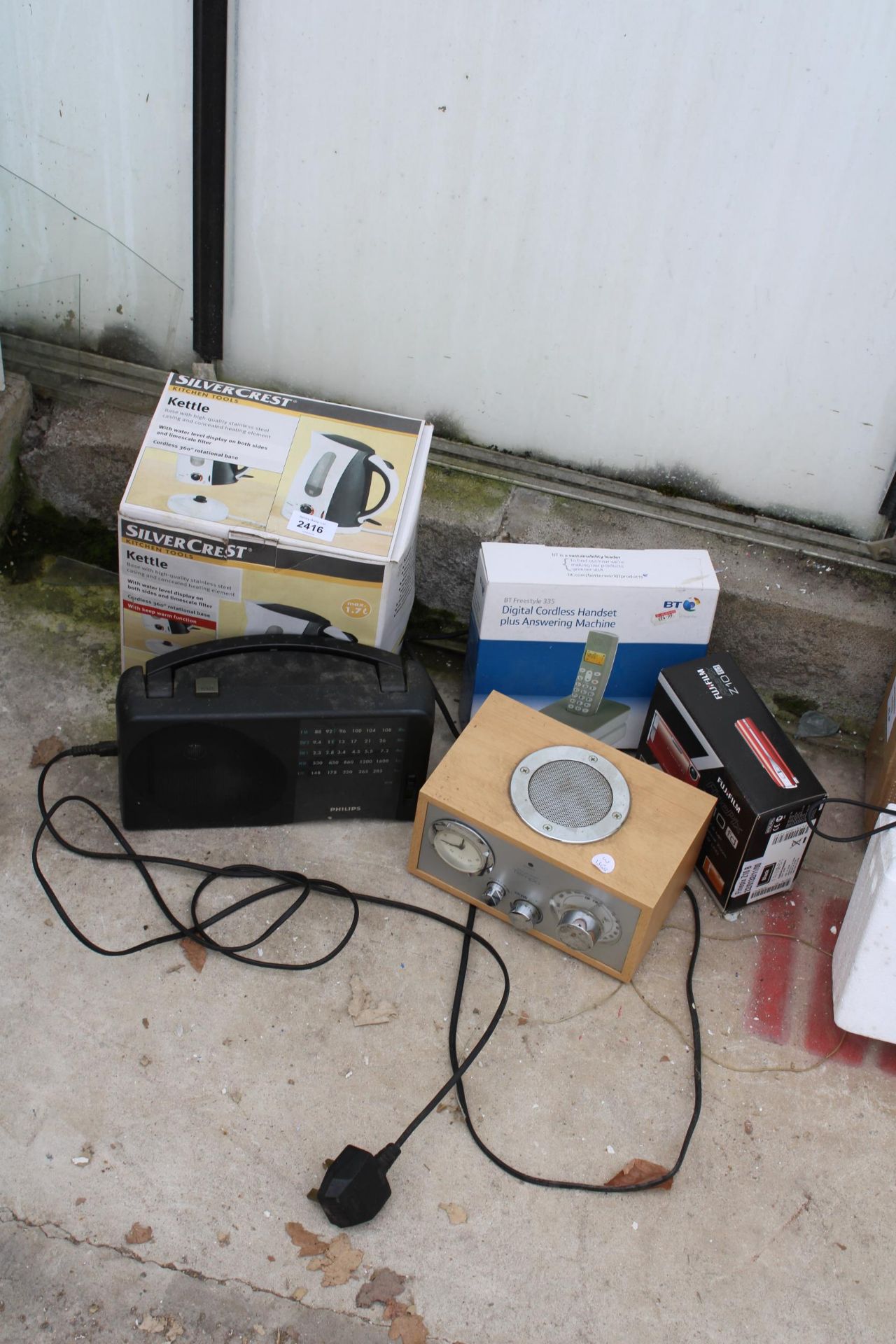 AN ASSORTMENT OF ITEMS TO INCLUDE A CAMERA AND A RADIO ETC