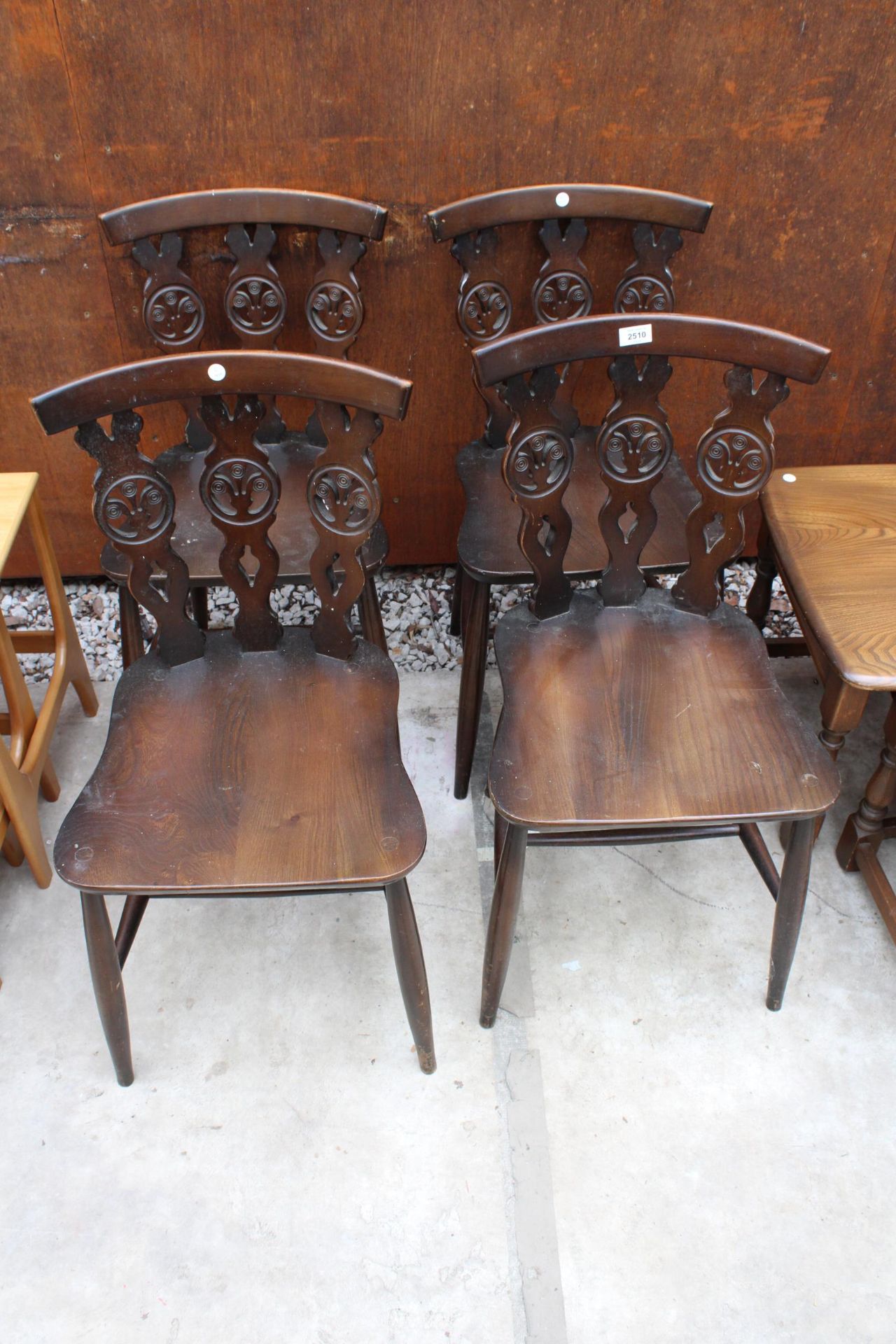 A SET OF FOUR ERCOL STYLE PLUME OF FEATHERS DINING CHAIRS