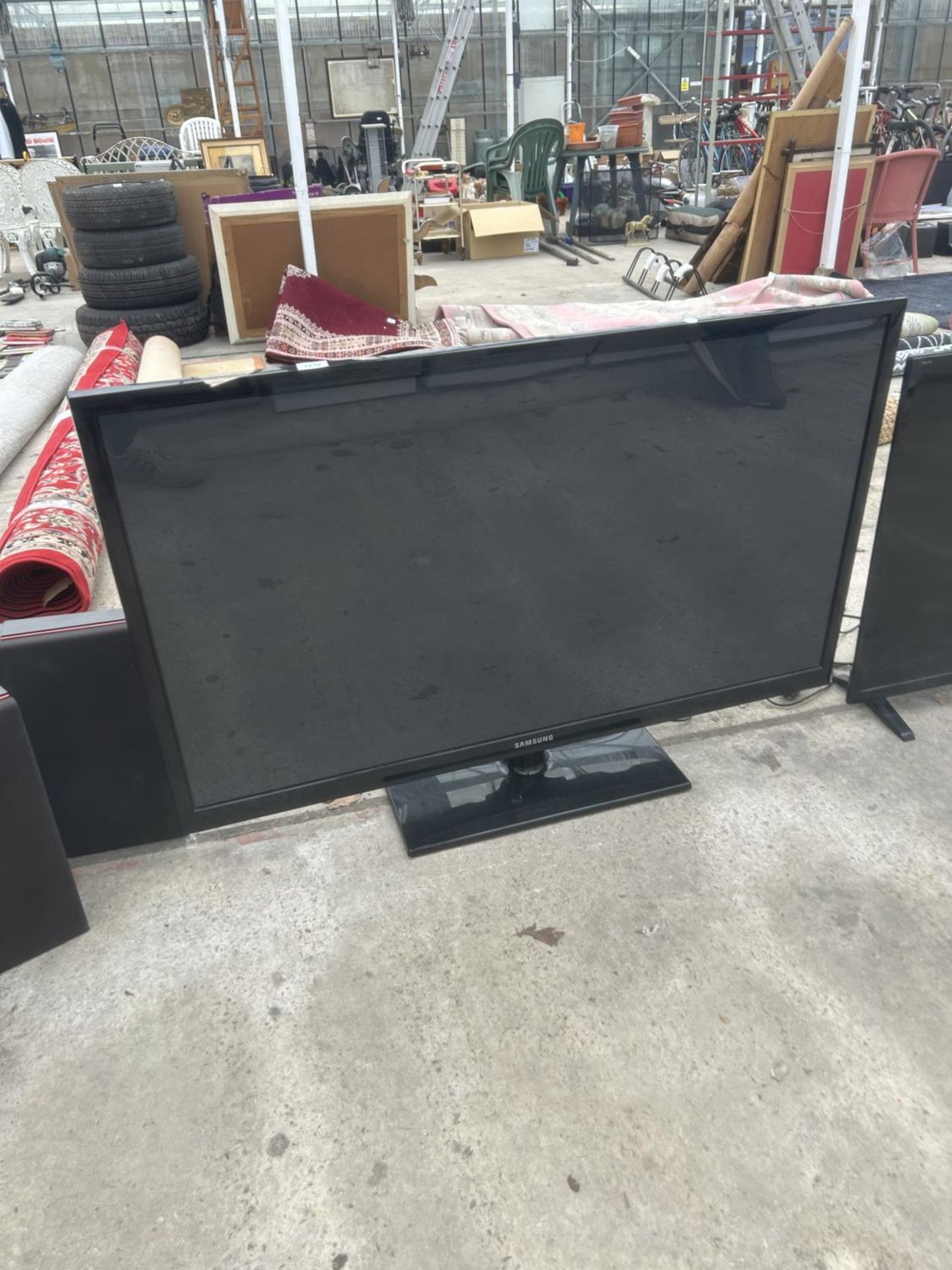 A SAMSUNG PLASMA DISPLAY TV WITH REMOTE