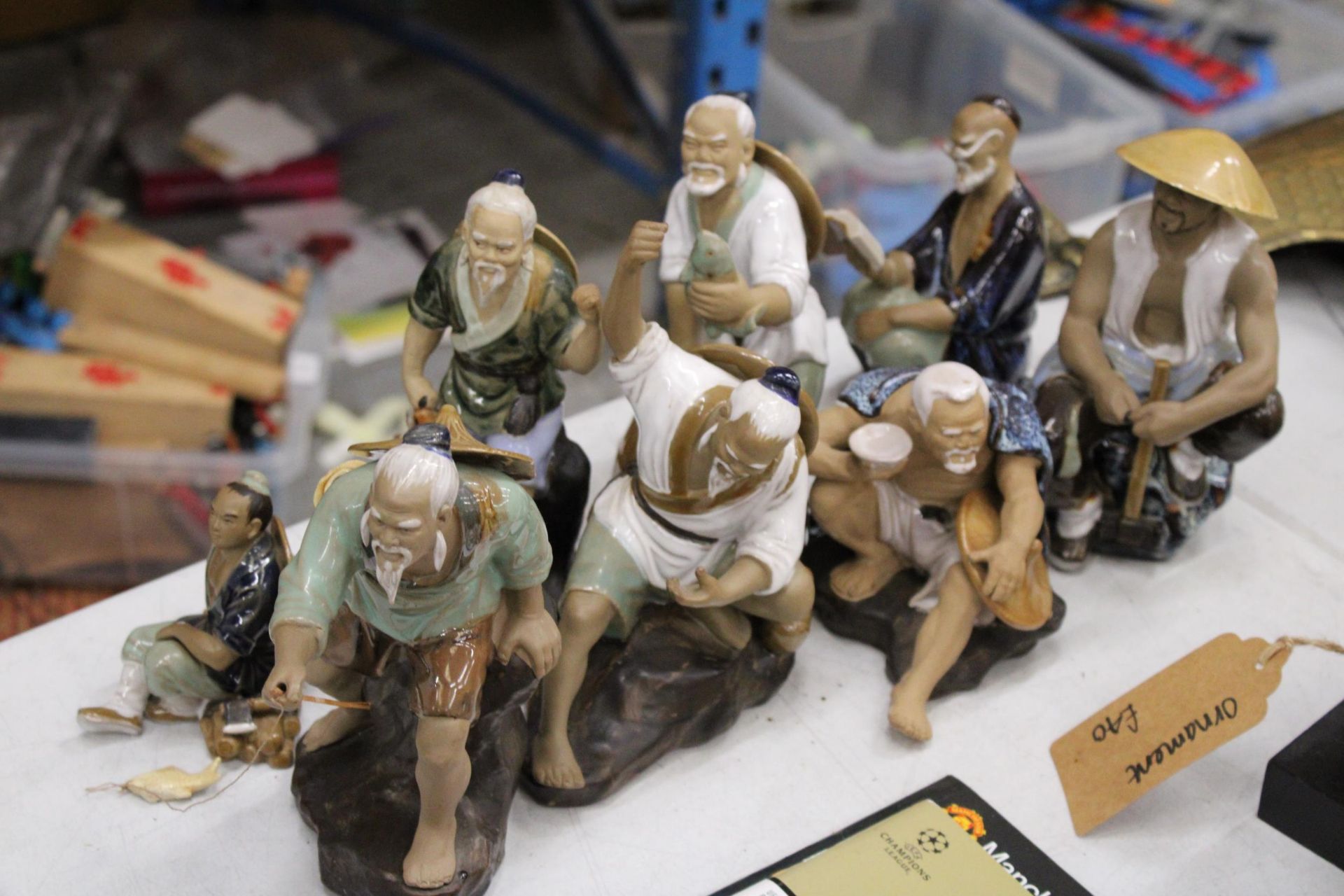 EIGHT FIGURES OF ORIENTAL MUD MEN