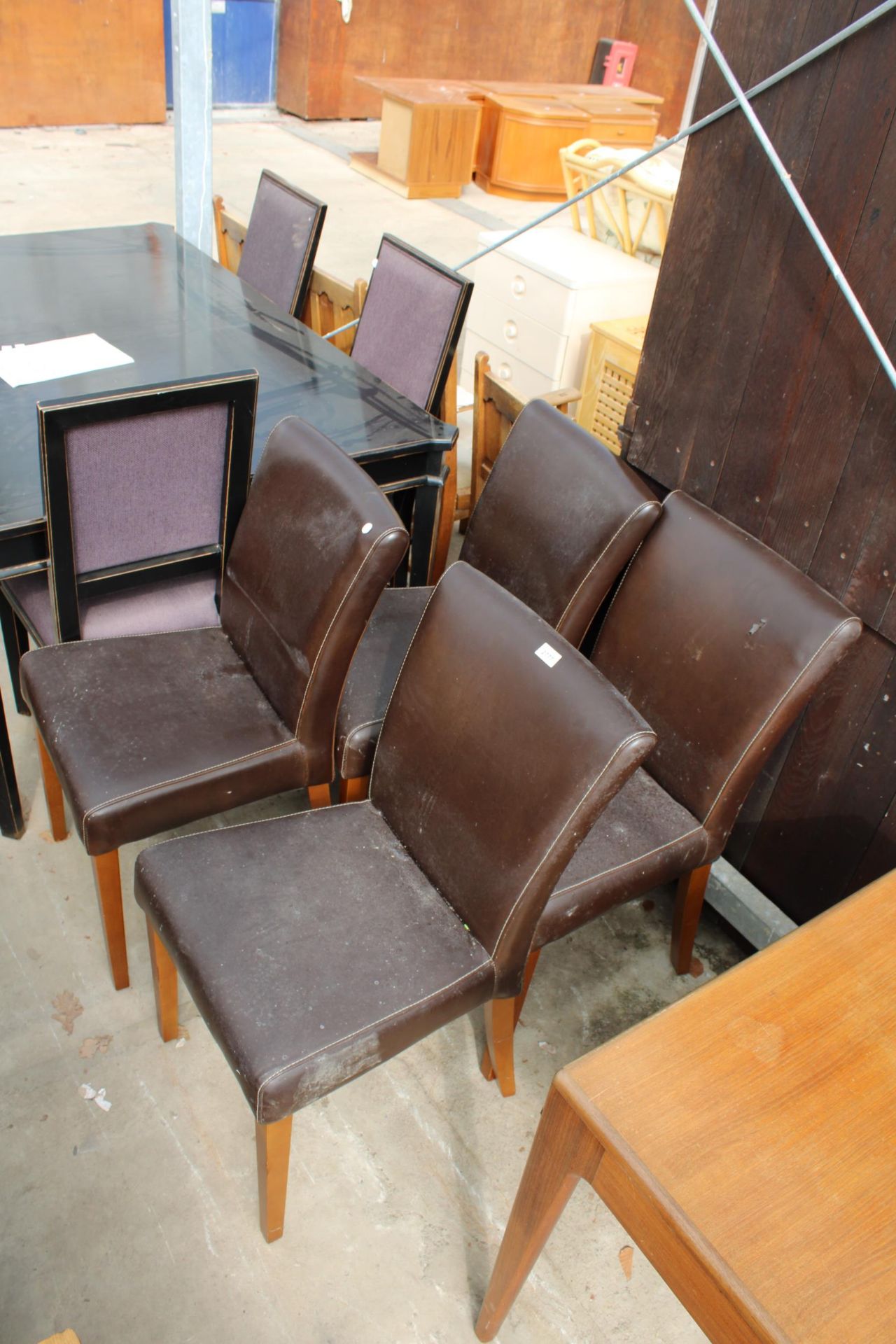 A SET OF FOUR MODERN FAUX LEATHER DINING CHAIRS