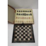 A VINTAGE MARBLE CHESS BOARD AND CHESS PIECES - COMPLETE